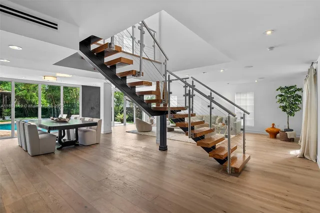 a kitchen with stainless steel appliances granite countertop a sink and a refrigerator