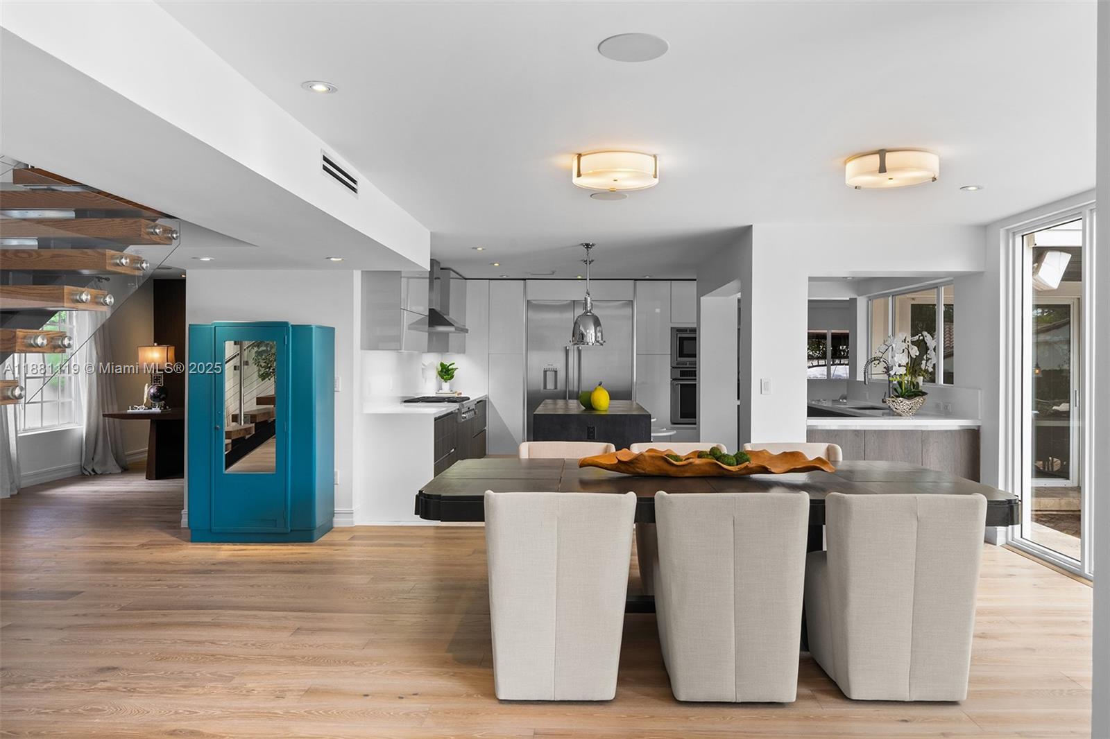 575 Bay Point Road Miami, FL 33137 - Photo 30 of 87 a dining room with wooden floor and large window