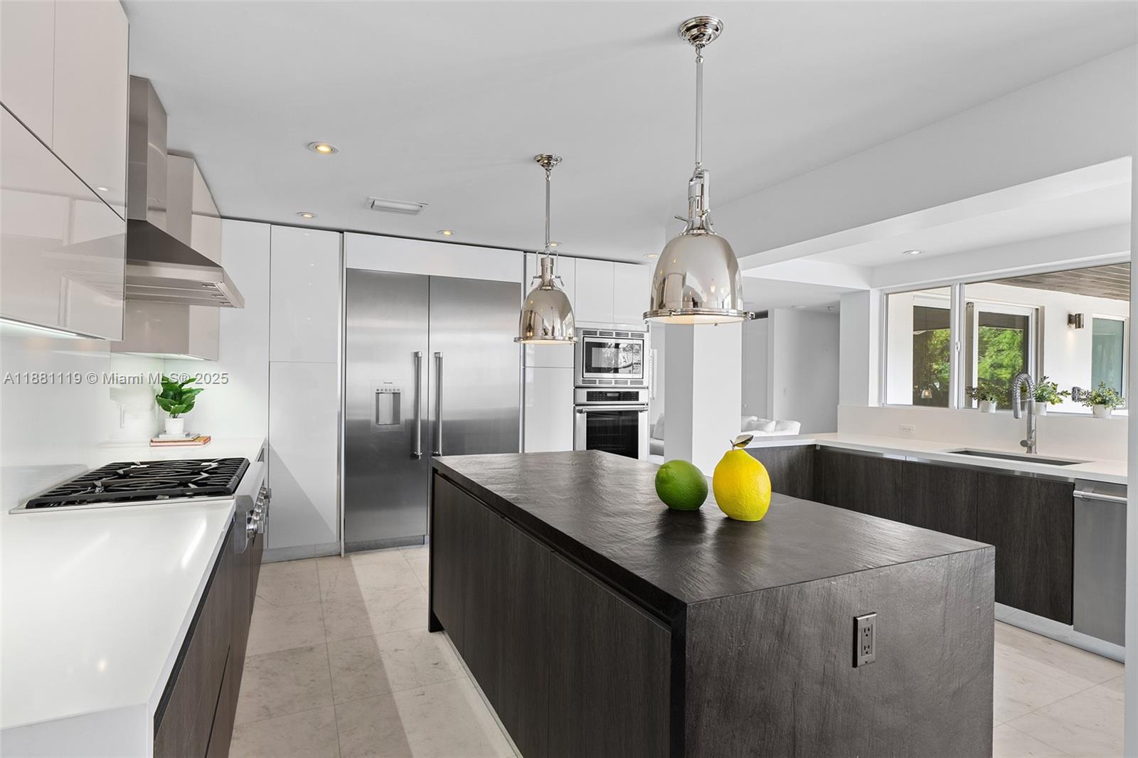 575 Bay Point Road Miami, FL 33137 - Photo 33 of 87 a kitchen with stainless steel appliances granite countertop a sink a refrigerator a stove and white cabinets