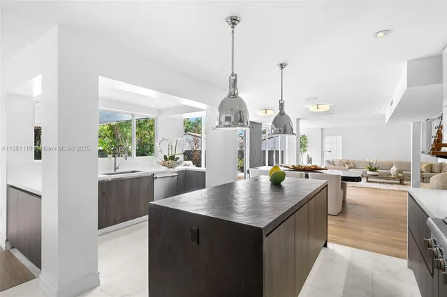a kitchen with stainless steel appliances granite countertop a stove and a refrigerator
