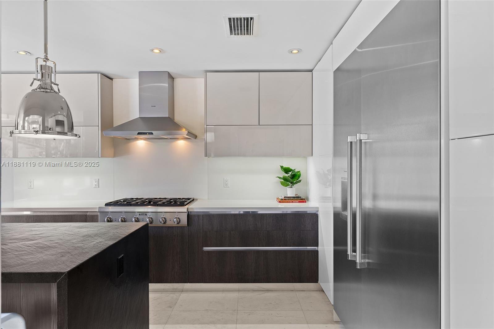 575 Bay Point Road Miami, FL 33137 - Photo 37 of 87 a kitchen with stainless steel appliances granite countertop a sink and a refrigerator