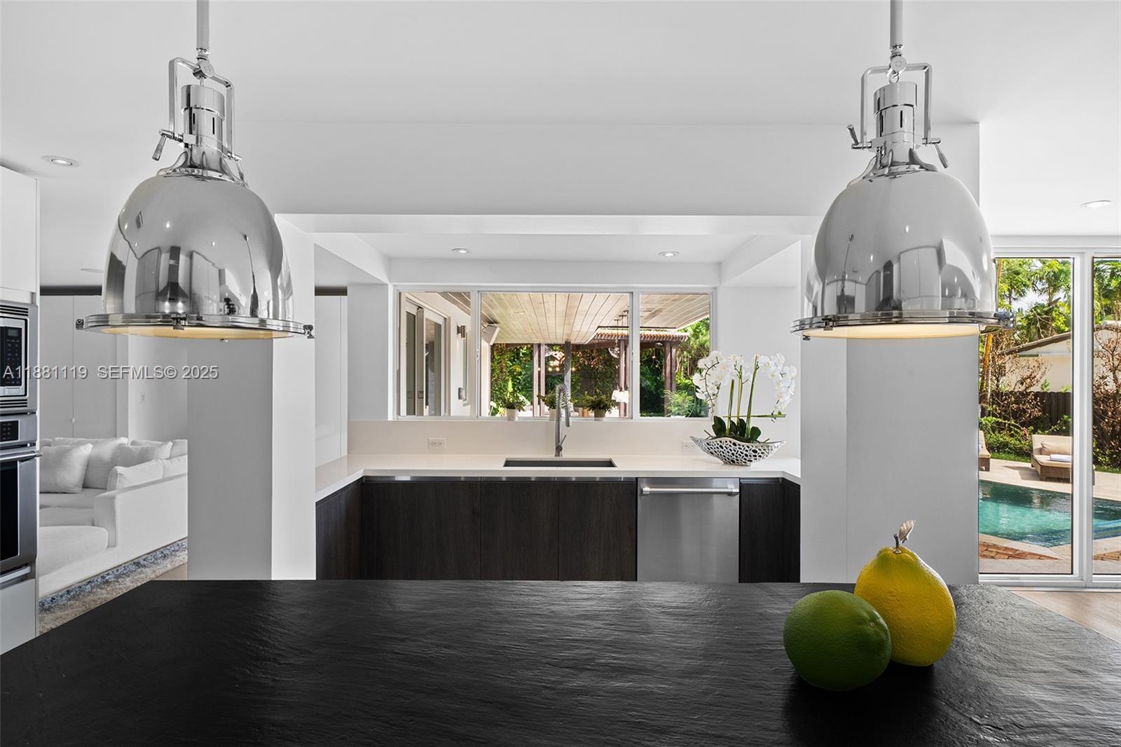 575 Bay Point Road Miami, FL 33137 - Photo 40 of 87 a view of kitchen and dining room with wooden floor