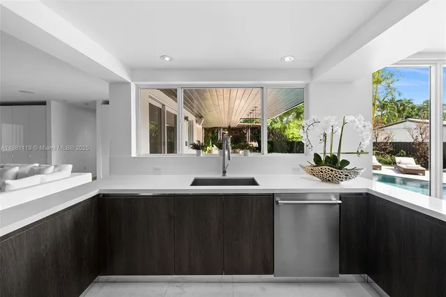 front view of a house with swimming pool and sitting area