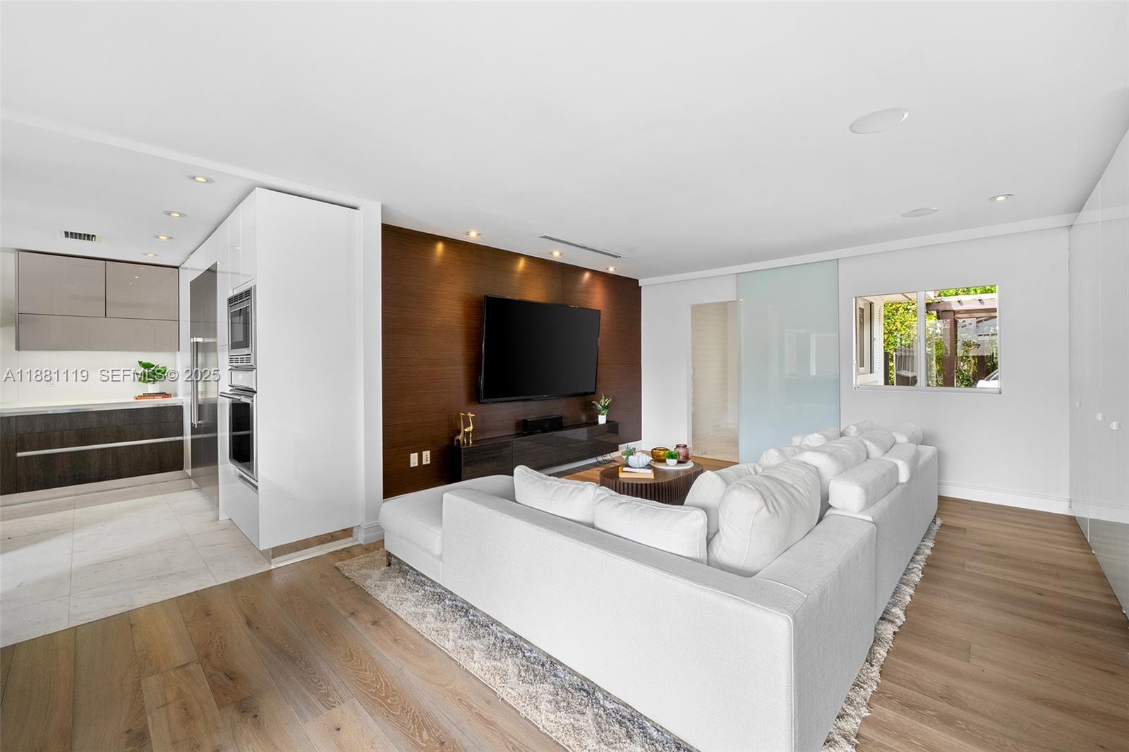 575 Bay Point Road Miami, FL 33137 - Photo 42 of 87 a living room with furniture and a flat screen tv