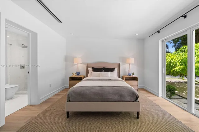 a front view of a house with a yard and trees