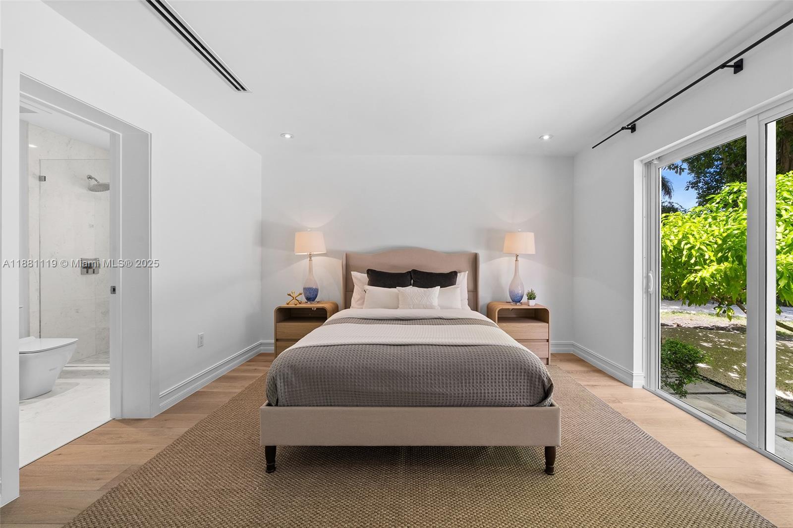 575 Bay Point Road Miami, FL 33137 - Photo 45 of 87 a spacious bedroom with a bed and a large window