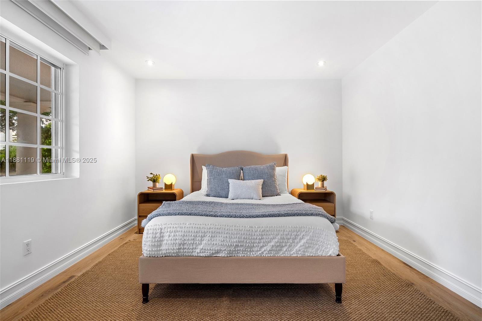 575 Bay Point Road Miami, FL 33137 - Photo 57 of 87 a bed sitting in a bedroom next to a window