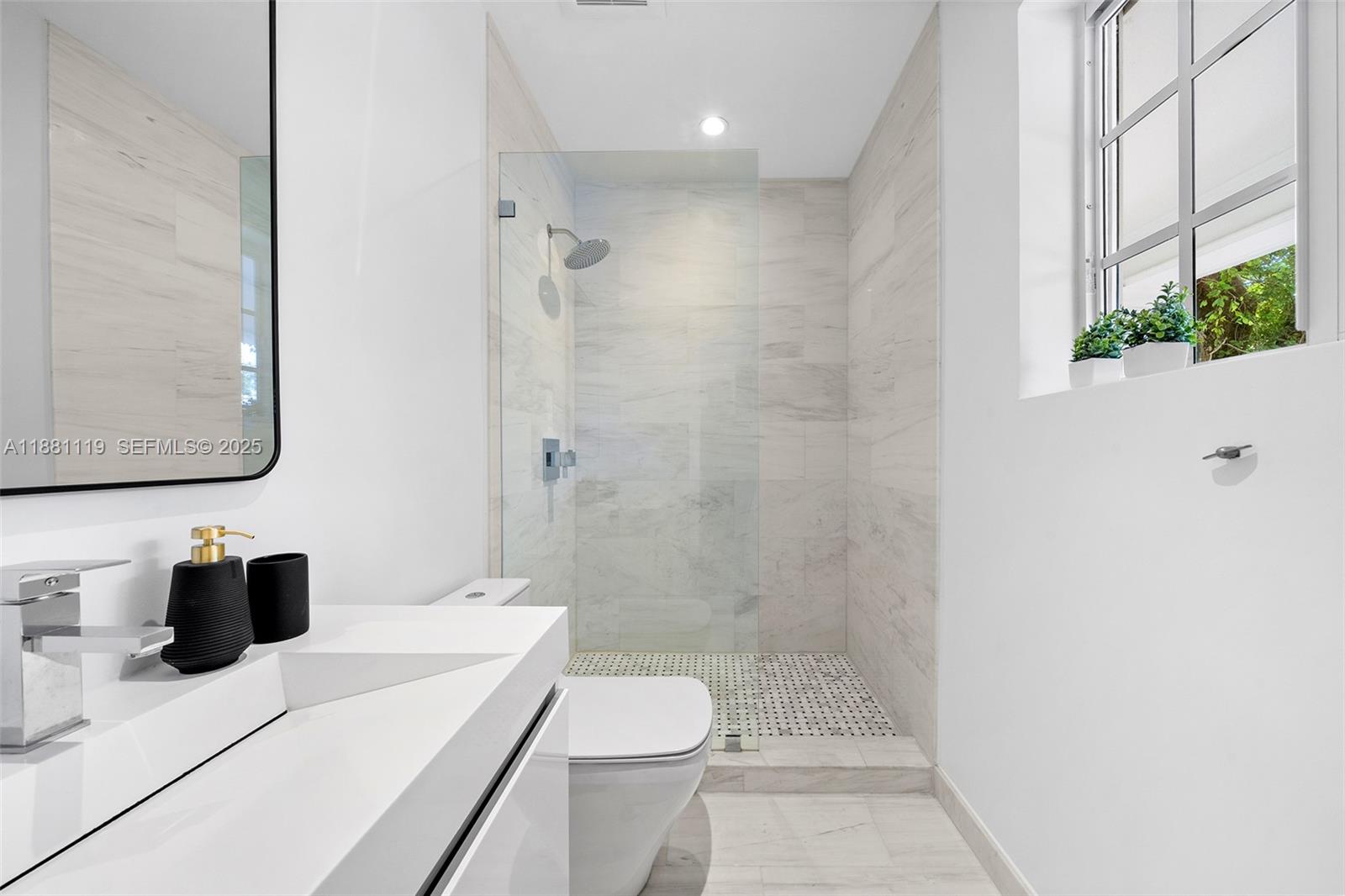 575 Bay Point Road Miami, FL 33137 - Photo 60 of 87 a bathroom with a sink a toilet and shower