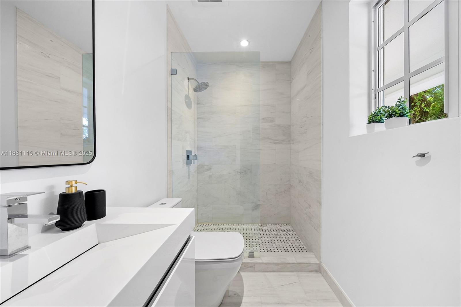 575 Bay Point Road Miami, FL 33137 - Photo 60 of 87 a bathroom with a sink a toilet and shower