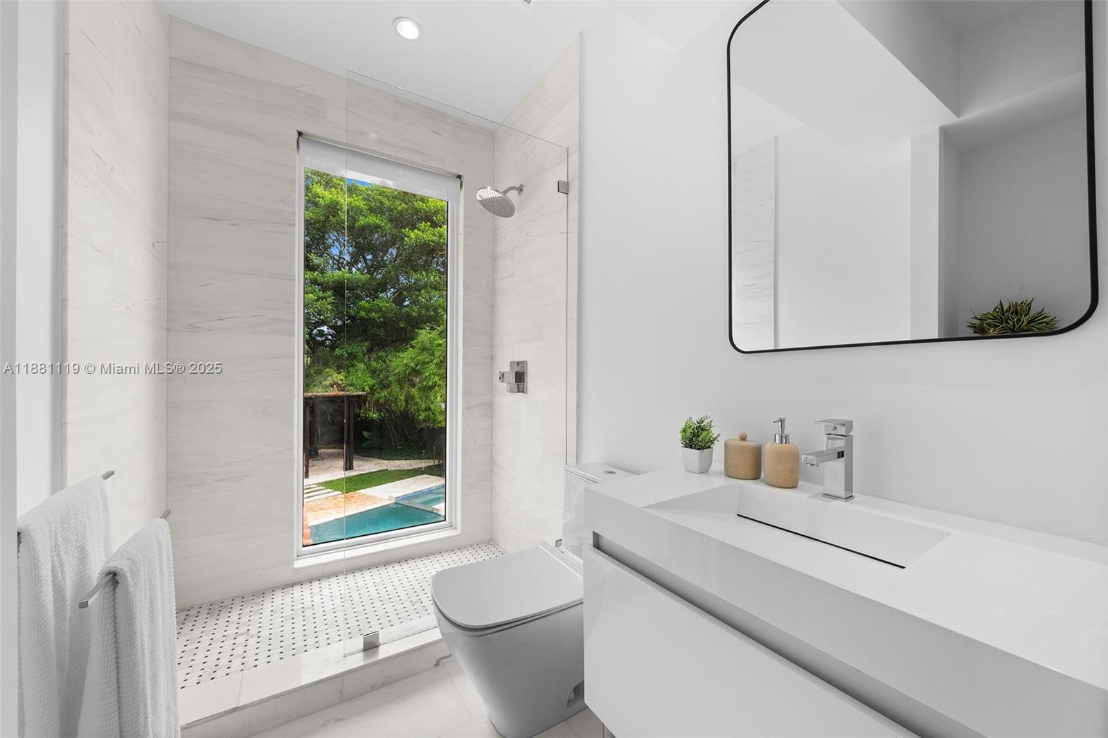 575 Bay Point Road Miami, FL 33137 - Photo 63 of 87 a bathroom with a toilet a sink and a window