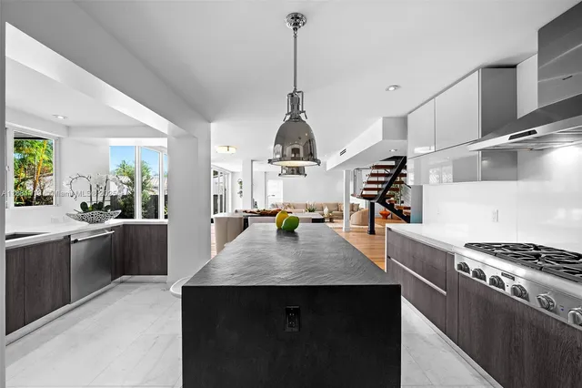 a living room with couches and painting on the wall with wooden floor