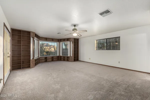 an empty room with a empty space and windows