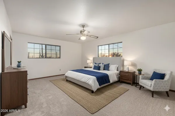 a spacious bedroom with a bed and a couch