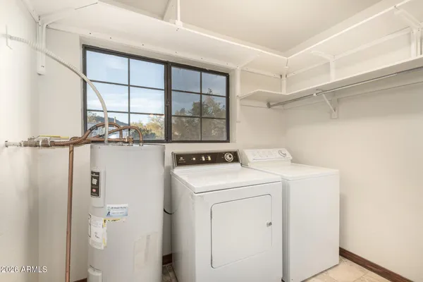 a view of a storage & utility room with dryer and washer