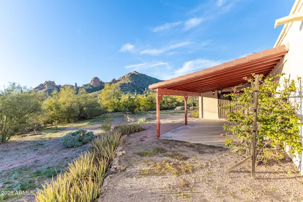 a backyard of a house with table and chairs