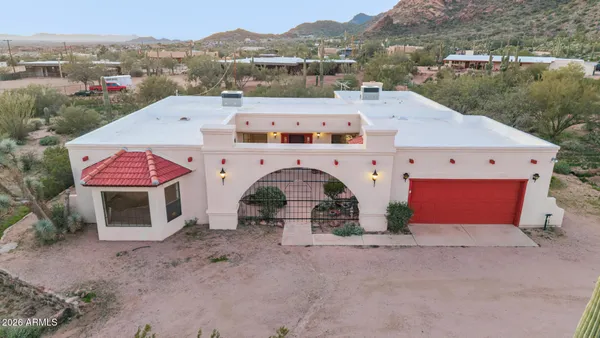 an aerial view of a house with a yard