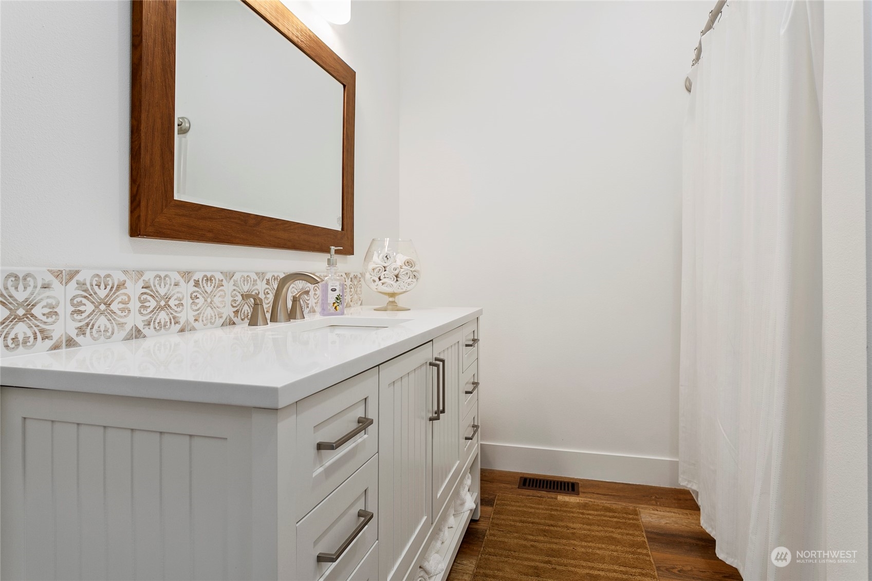 7730 Goodwin Road Everson, WA 98247 - Photo 24 of 39 a bathroom with a sink and a mirror
