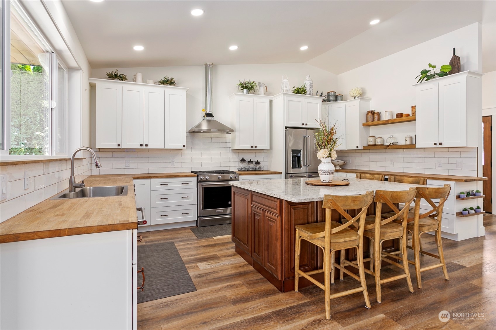 7730 Goodwin Road Everson, WA 98247 - Photo 6 of 39 a large kitchen with stainless steel appliances granite countertop a stove a sink and a refrigerator