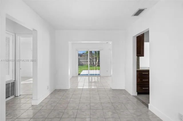 a view of an empty room with glass door