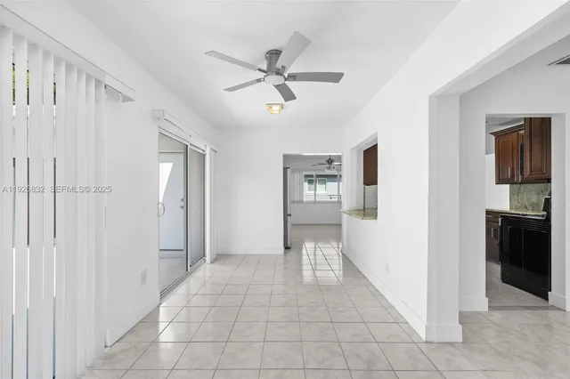 a view of a hallway with closet and a window