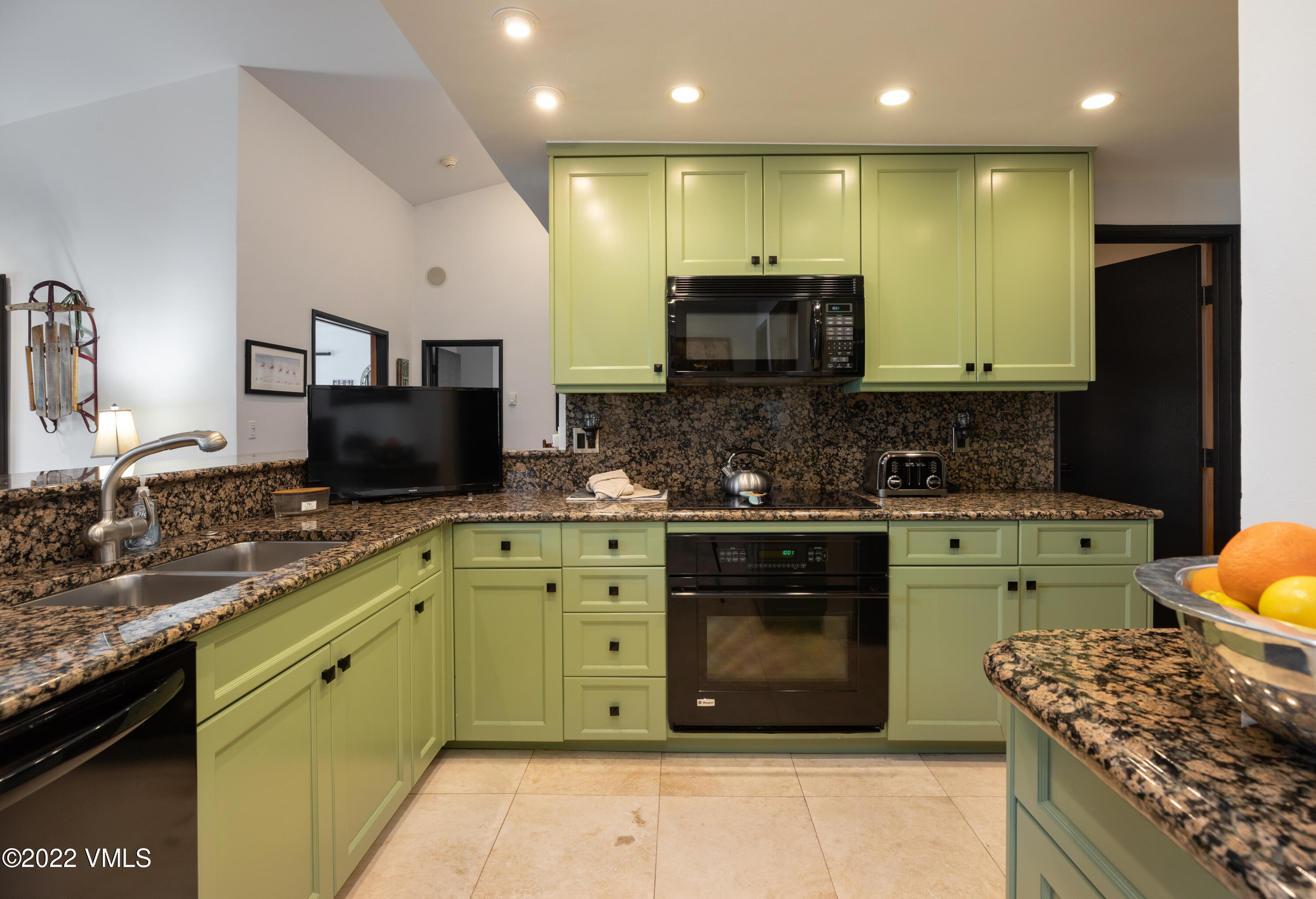 120 Offerson Road, Unit E440 Beaver Creek, CO 81620 - Photo 5 of 22 a kitchen with stainless steel appliances granite countertop a stove a sink and a microwave