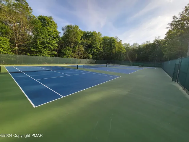 a view of an outdoor space and basketball court