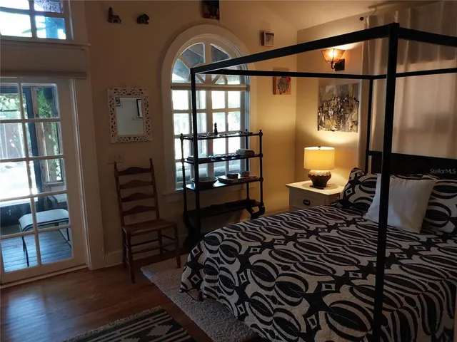 a bedroom with a bed next to a window