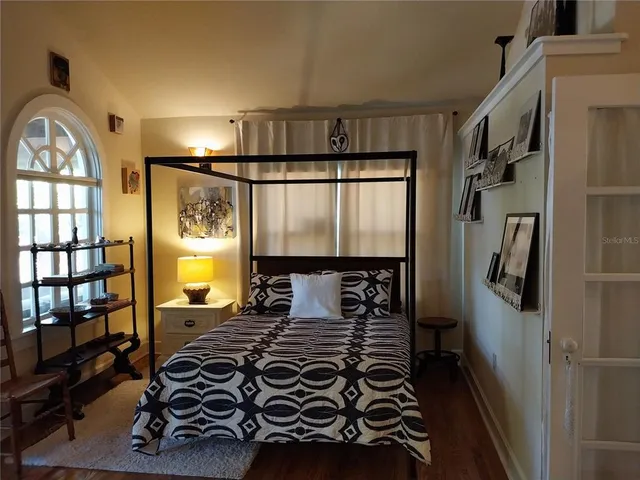 a bedroom with a bed and a window