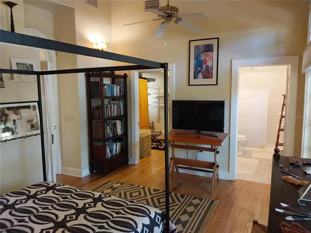 a bedroom with a bed and a flat screen tv