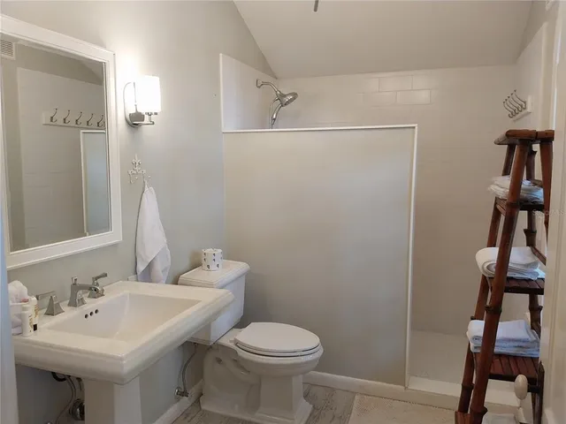 a bathroom with a sink toilet and a mirror