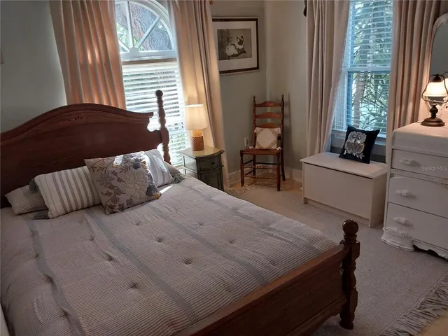 a bedroom with a bed and a chair