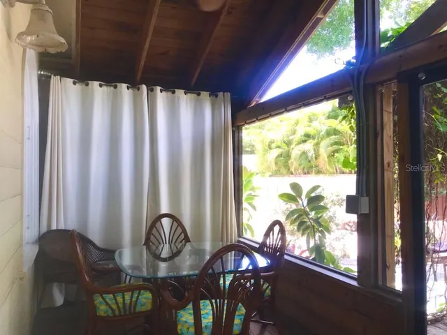 a table with chairs and a window