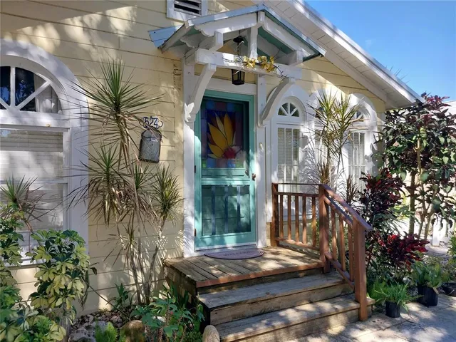 a view of front door of house with stairs