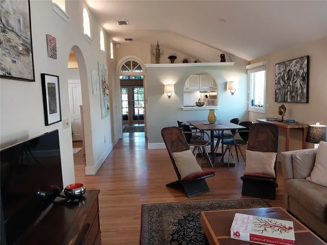 a living room with furniture wooden floor and a flat screen tv