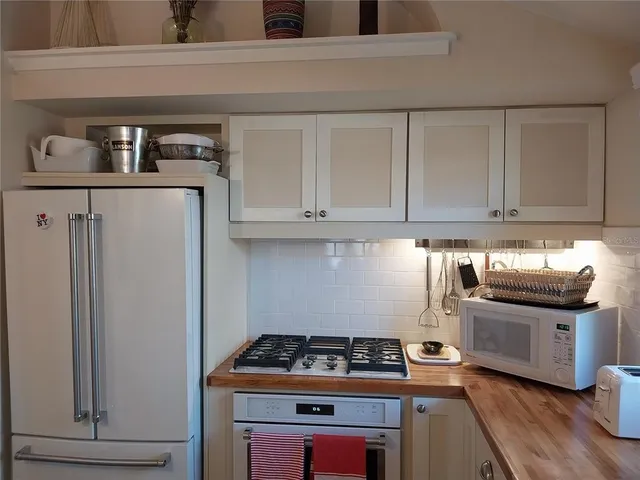 a kitchen with stainless steel appliances granite countertop a stove and a refrigerator