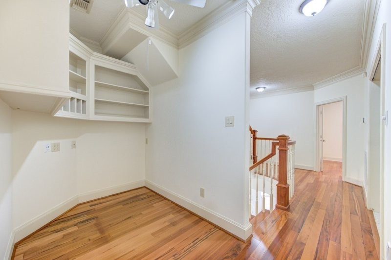 122 Vieux Carre Drive Houston, TX 77009 - Photo 19 of 47 a view of a hallway with wooden floor and staircase