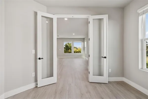 a large white kitchen with stainless steel appliances granite countertop a stove a sink and a refrigerator