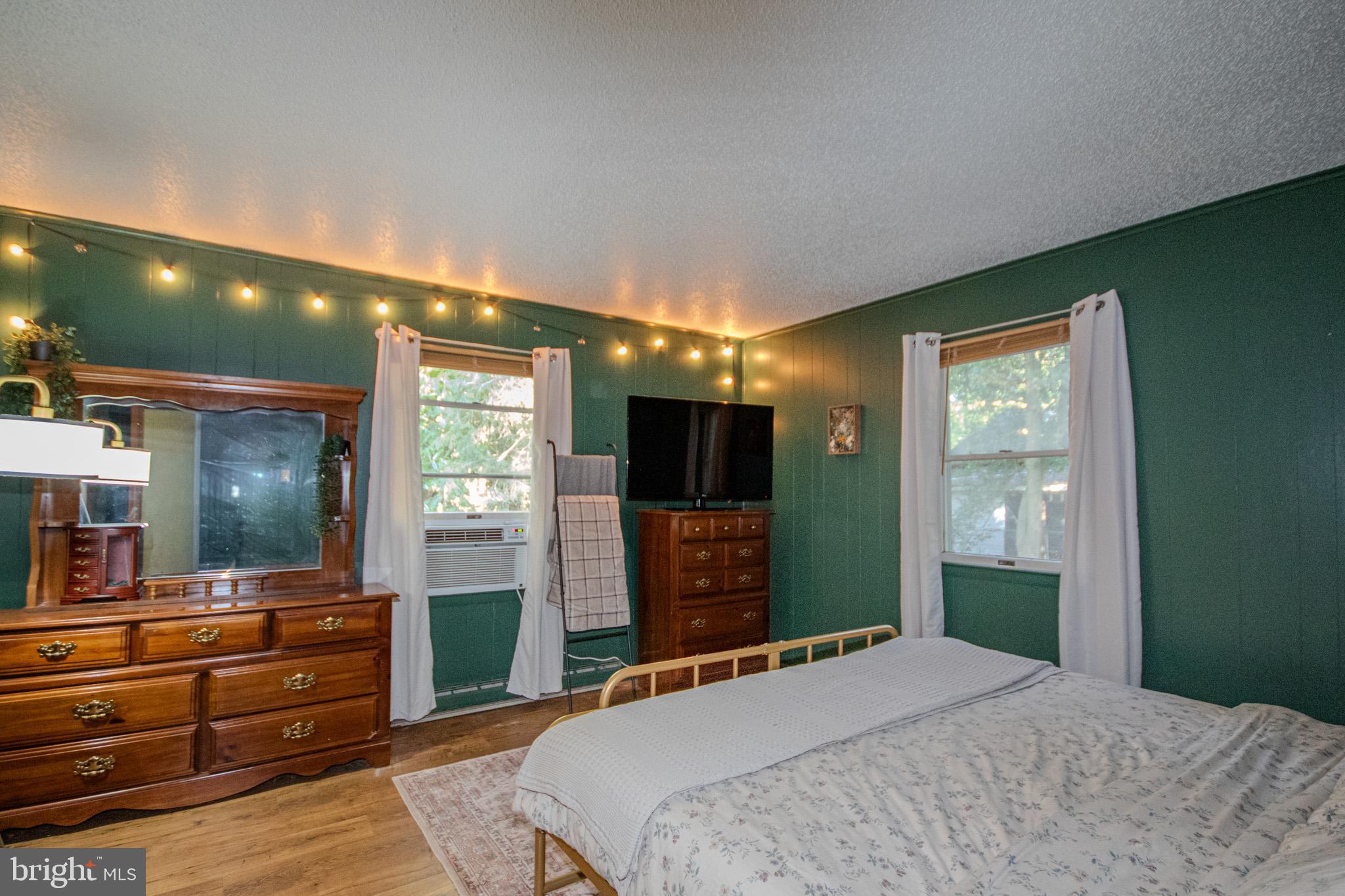 7218 Walston Switch Road Parsonsburg, MD 21849 - Photo 15 of 28 a bedroom with a bed and a flat screen tv