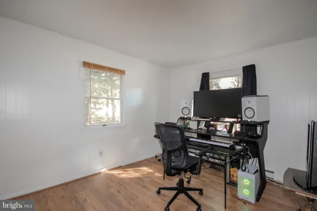 a workspace with furniture and a flat screen tv