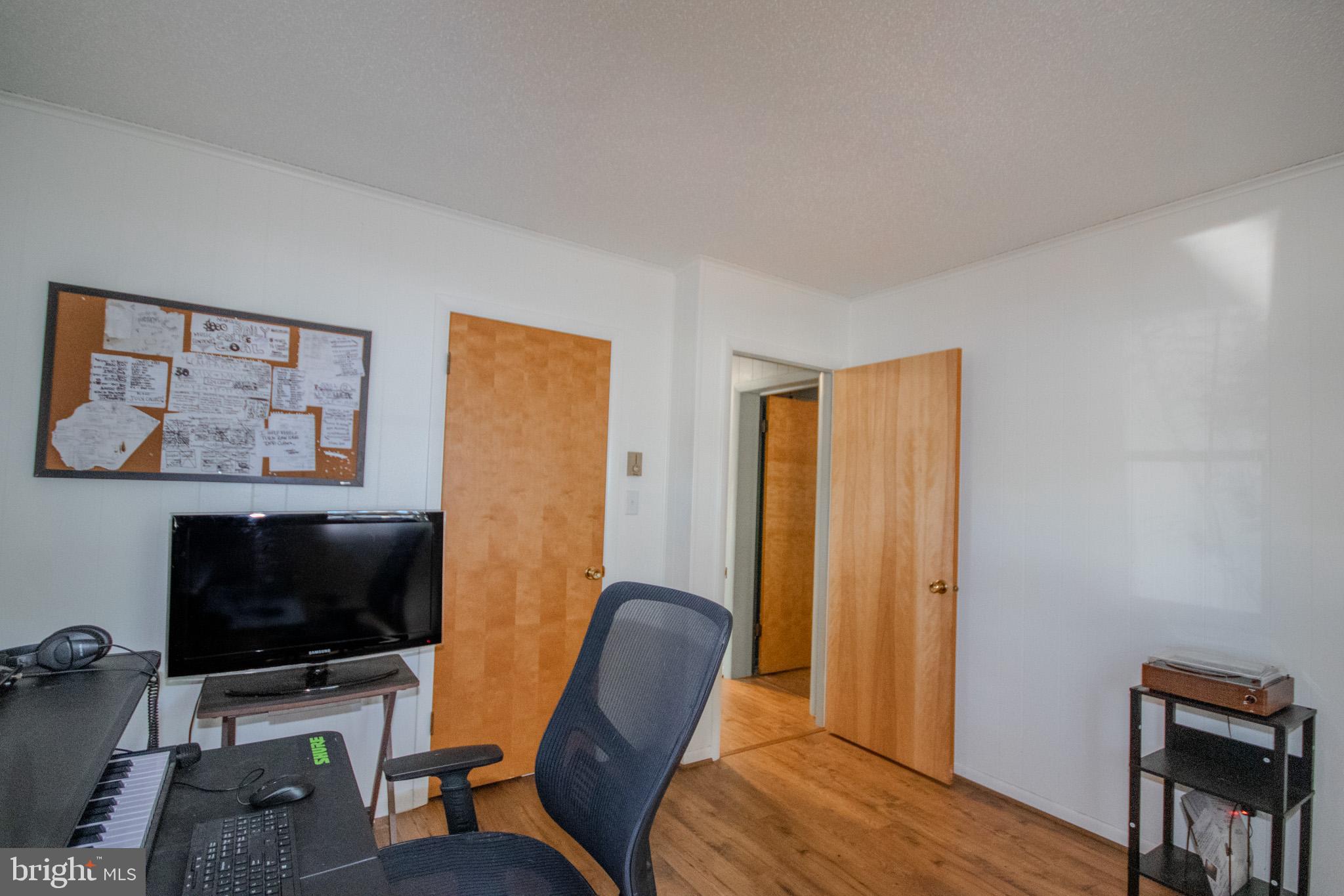 7218 Walston Switch Road Parsonsburg, MD 21849 - Photo 18 of 28 a workspace with furniture and a flat screen tv