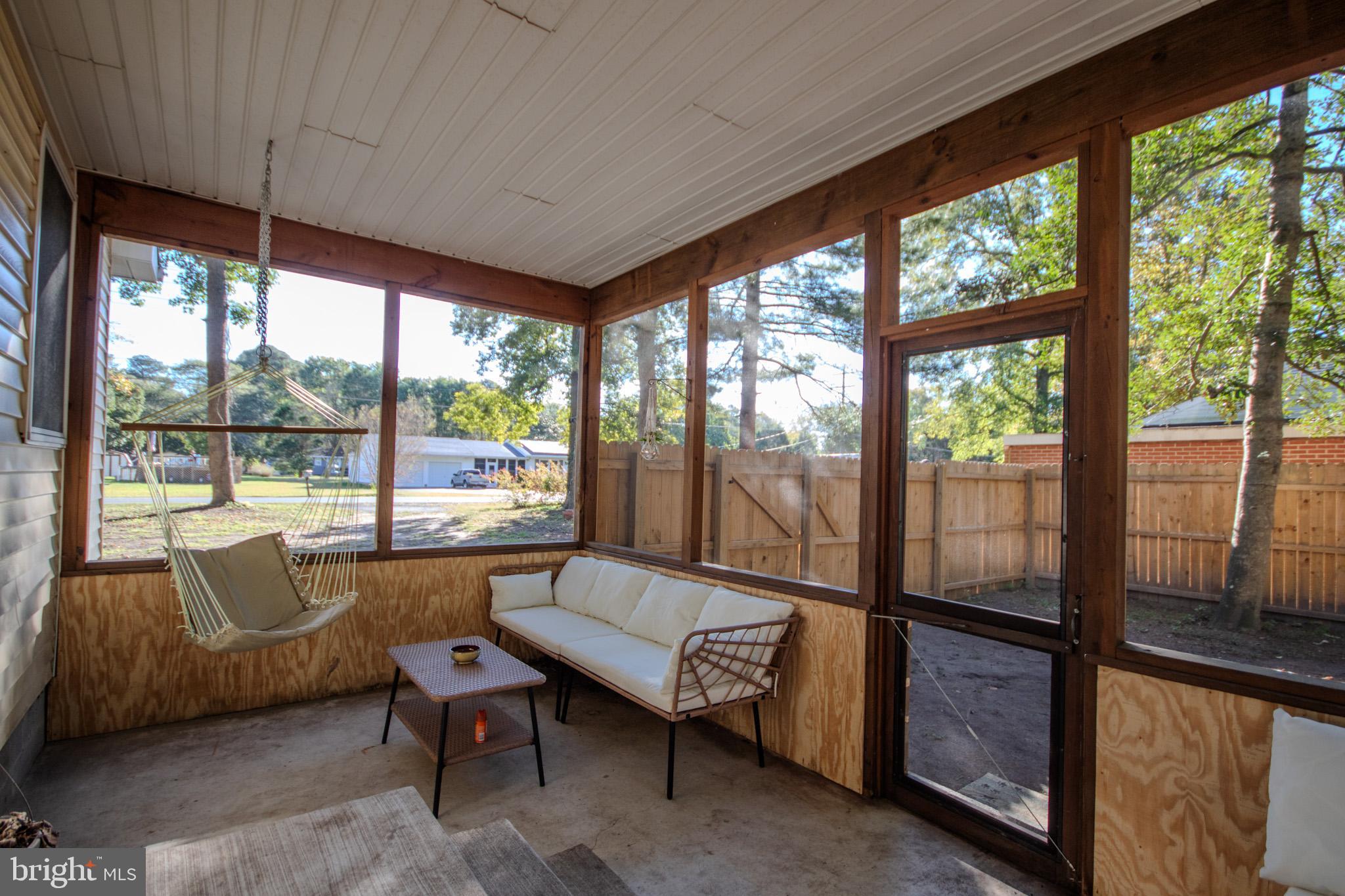 7218 Walston Switch Road Parsonsburg, MD 21849 - Photo 20 of 28 a living room with furniture and a floor to ceiling window