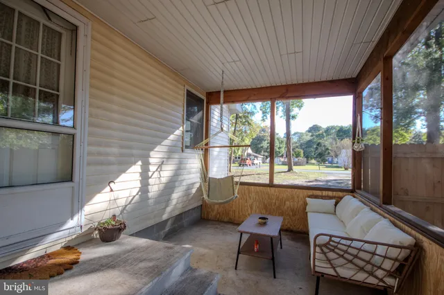 a living room with a large window and furniture