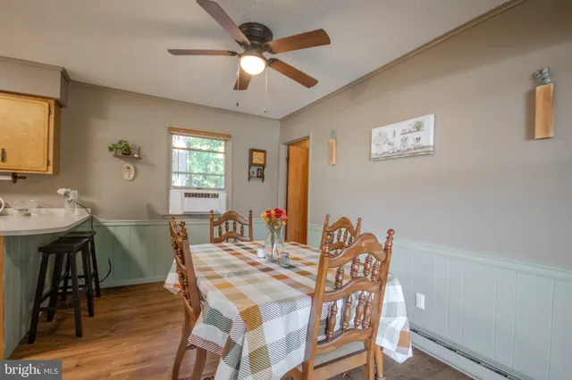 a view of a dining room with furniture window and wooden floor