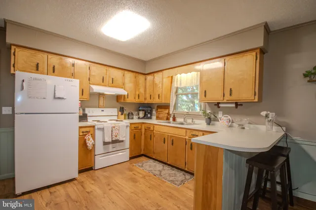 a kitchen with a refrigerator a sink and dishwasher
