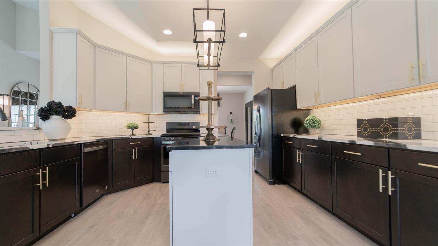 3098 Fawn Lane Portage, IN 46368 - Photo 9 of 22 a kitchen with stainless steel appliances granite countertop a refrigerator a sink dishwasher a stove and a microwave oven on the table