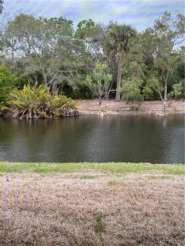 an aerial view of a houses with a lake