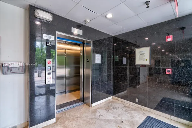 a kitchen with stainless steel appliances kitchen island granite countertop a refrigerator and a sink