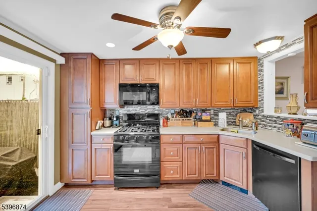 a kitchen with a stove window and cabinets