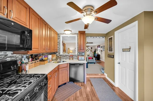 a kitchen with a stove a sink and a refrigerator