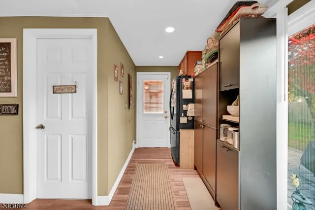 a view of a hallway with wooden shelves